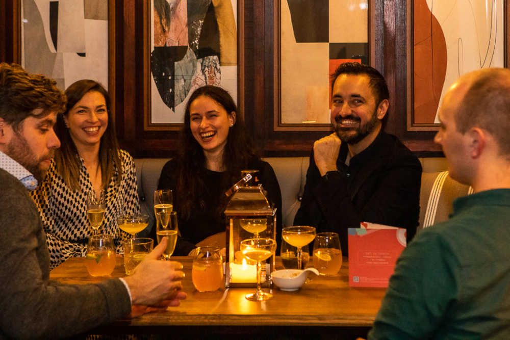 a group of people enjoying themselves laughing and smiling